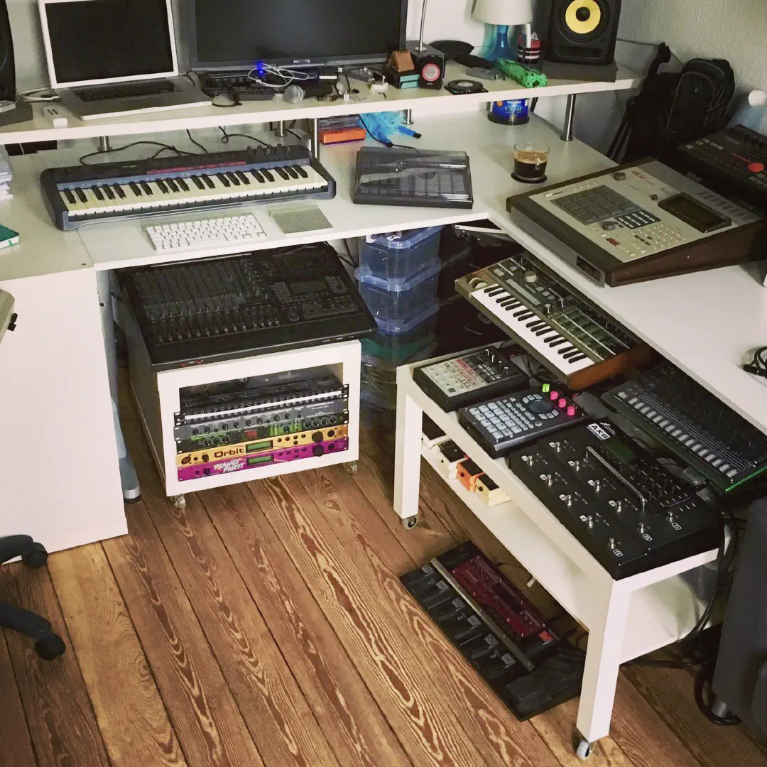 A desk filled with a shitload of musical equipment