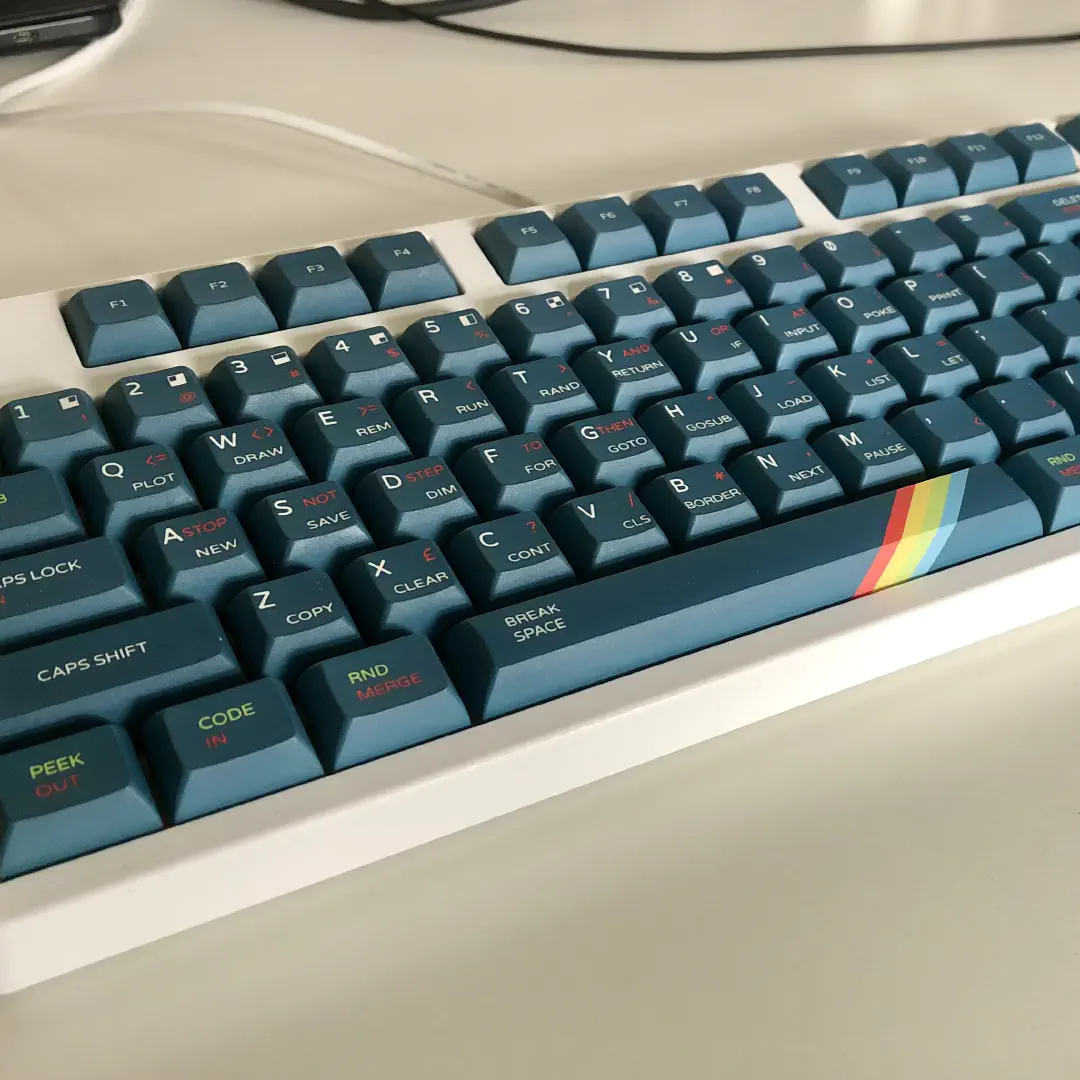 White keyboard with keycaps in the style of the Sinclair ZX Spectrum